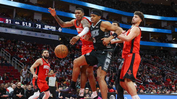 Rockets forward Jabari Smith Jr. (10) and San Antonio Spurs forward Keldon Johnson (3) attempt to get a loose ball during the fourth quarter at Toyota Center.
